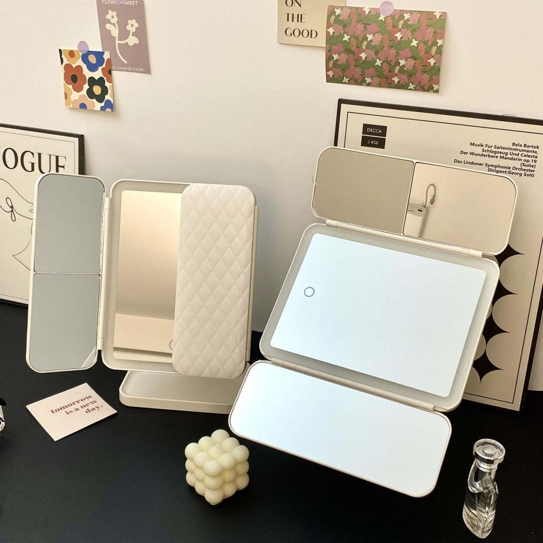 Elegant LED tri-fold vanity mirror with 3 light colors, a stylish and functional home decor beauty tool.