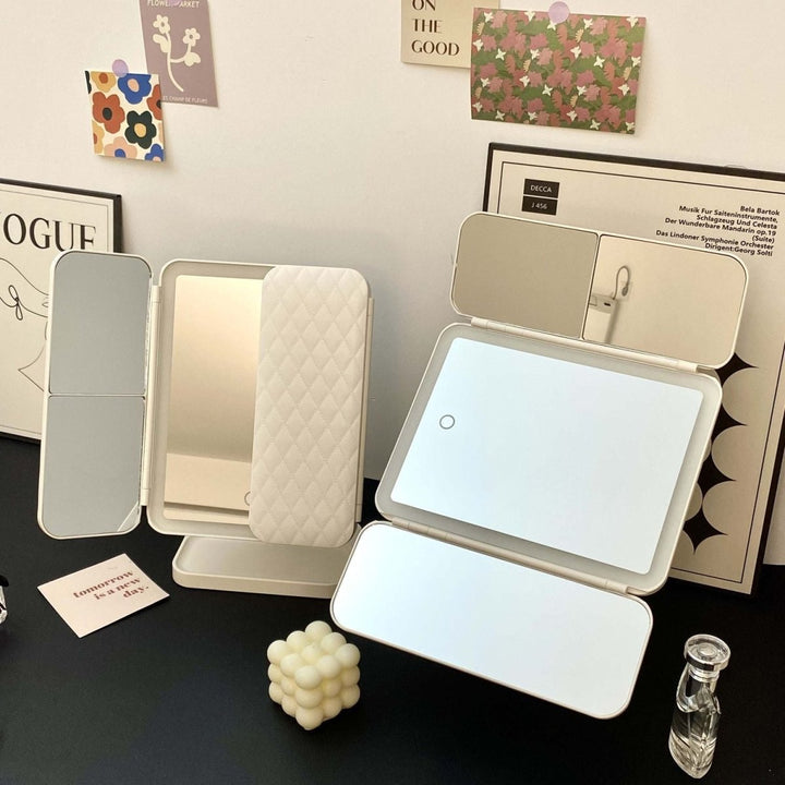 Elegant LED tri-fold vanity mirror with 3 light colors, a stylish and functional home decor beauty tool.