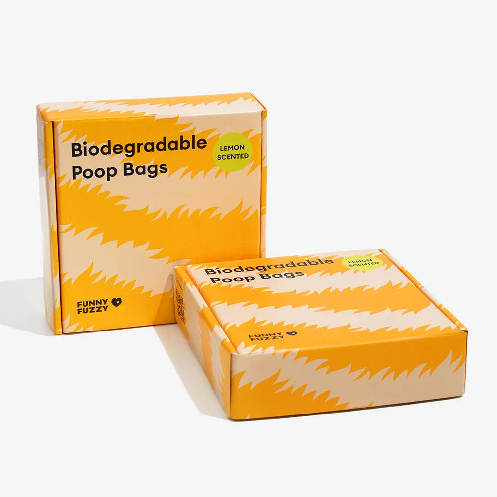 Close-up of lemon scented biodegradable dog bags, emphasizing 'biodegradable' text