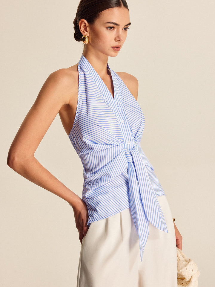 Casual chic light blue striped halter top with tie-front. Elegant sleeveless design for summer fashion.