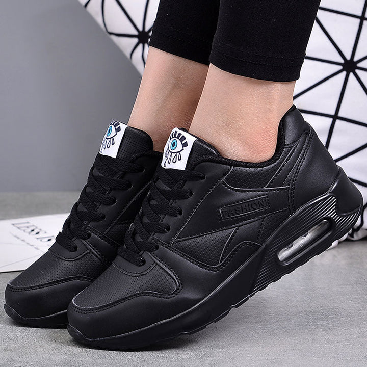 Fashionable black vegan leather women's platform sneakers, perfect for comfort and style.