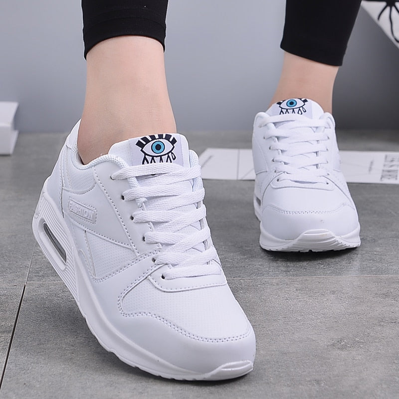 Elegant white platform sneakers for women, vegan leather design offering all-day comfort and style.