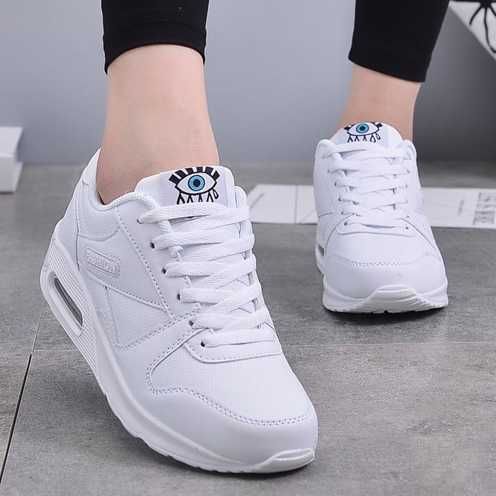 Elegant white platform sneakers for women, vegan leather design offering all-day comfort and style.