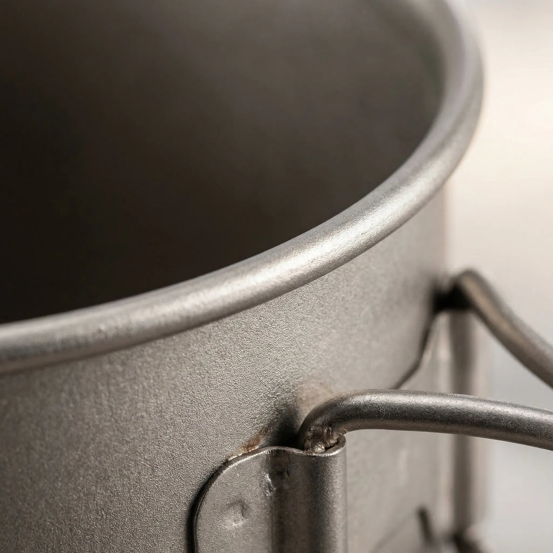 Complete titanium hiking equipment set: pot, mug, and spork. Ideal for a lightweight trail kitchen.