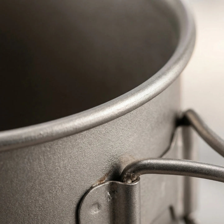 Complete titanium hiking equipment set: pot, mug, and spork. Ideal for a lightweight trail kitchen.