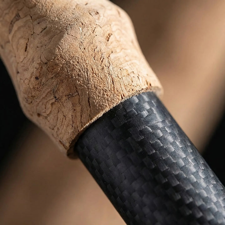Ergonomic handle of a lightweight trekking pole, designed for comfortable grip during long hikes.