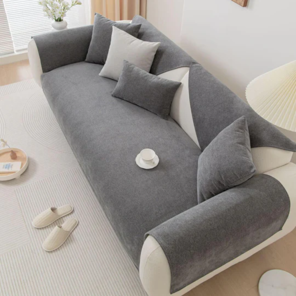 Beige linen blend sectional slipcover protecting a large living room sofa with non-slip feature