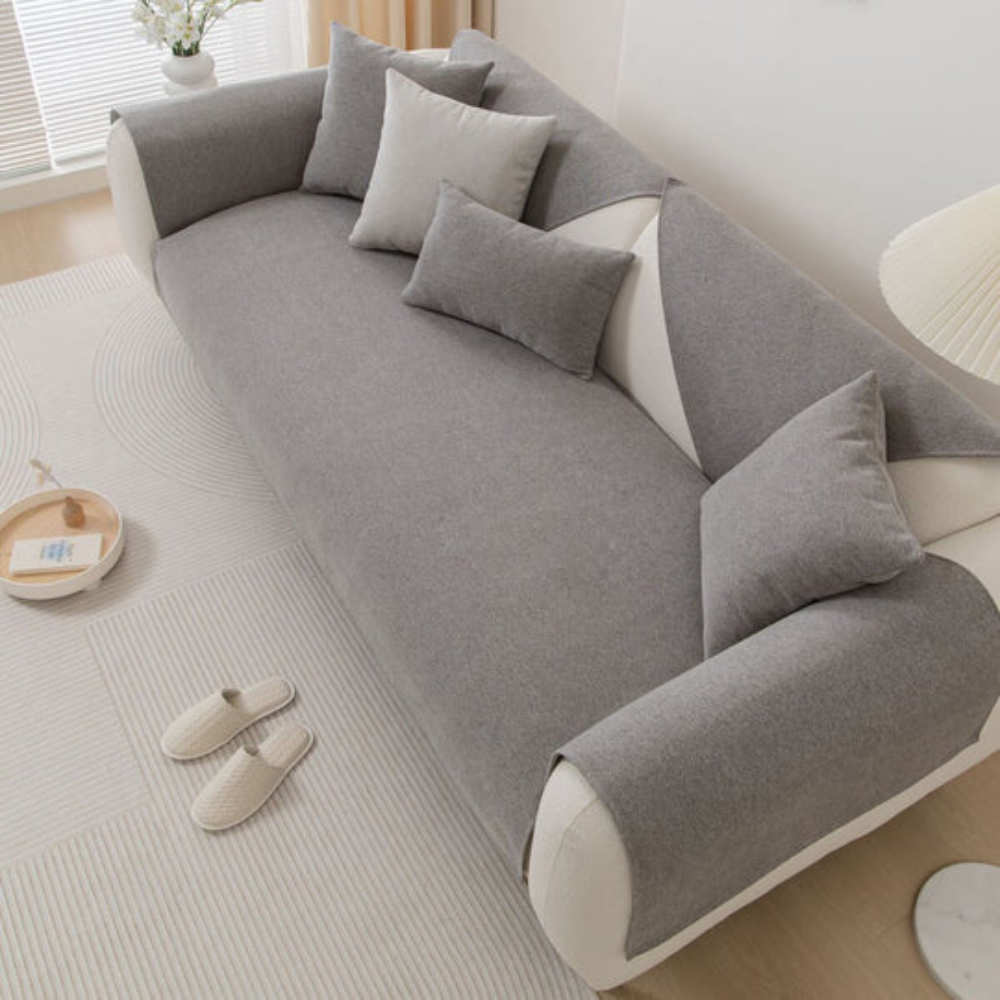 View of a modern sectional sofa covered by a blue linen blend slipcover with non-slip backing