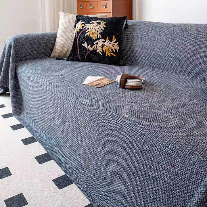 Full view of a living room featuring a stylish linen-look furniture protector on a sofa