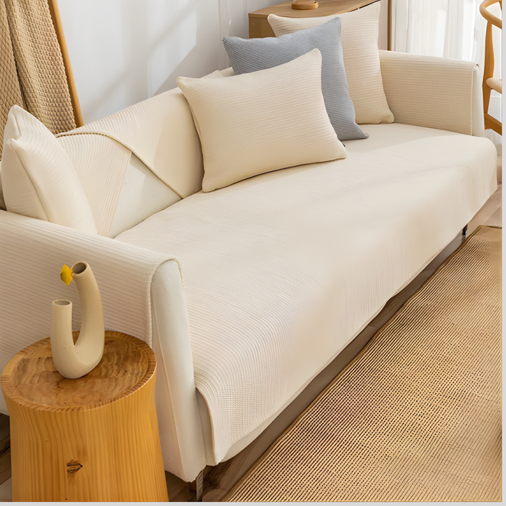 Close-up of linen sectional sofa cover material, showing anti-slip backing for furniture protection
