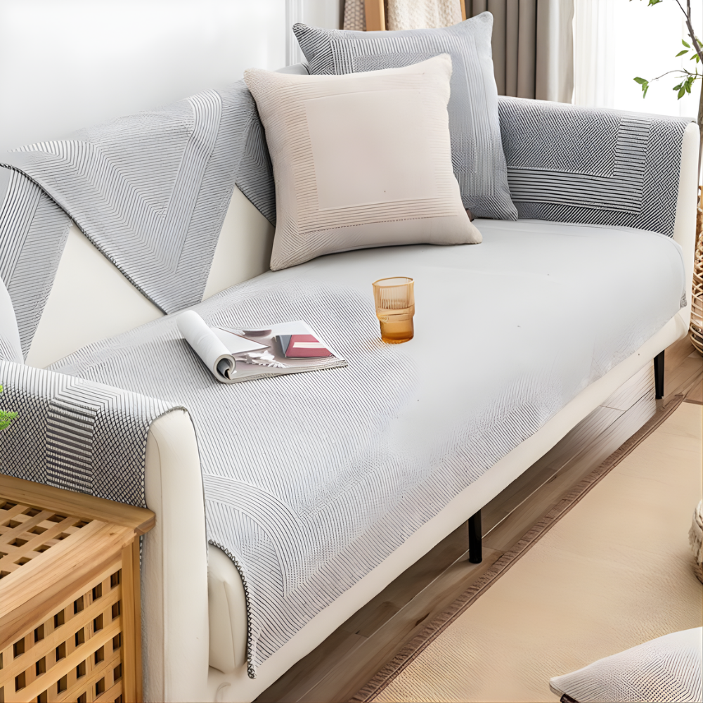 Sectional sofa covered in elegant beige linen fabric, anti-slip protector for living room furniture