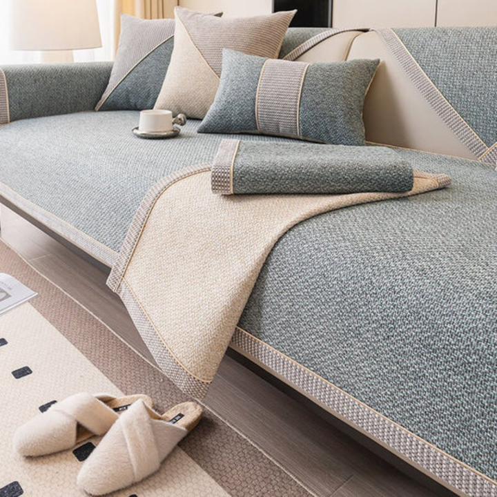 Overview of a living room with a cream linen sectional sofa, anti-slip cover providing full protection