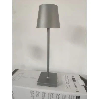 LumiAura dimmable LED table lamp creating warm ambiance. Portable, wireless & rechargeable for any space.