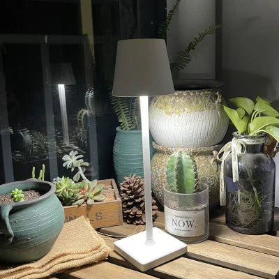 Wireless LumiAura portable LED lamp. Dimmable light for indoor/outdoor ambiance, rechargeable & modern design.