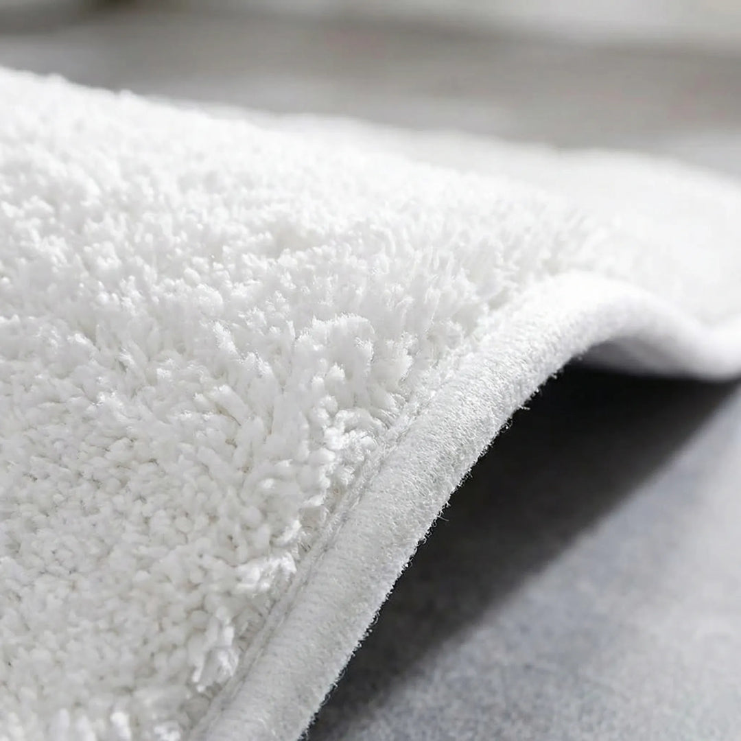 Soft, plush, washable bath mat offering extra thick comfort and non-slip safety for any bathroom.