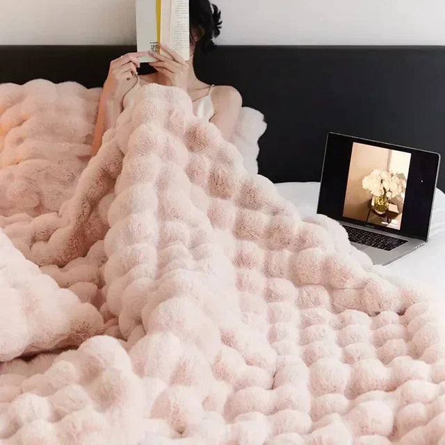 Cozy faux fur blanket for home, travel, or living room decor; anti-pilling and plush.