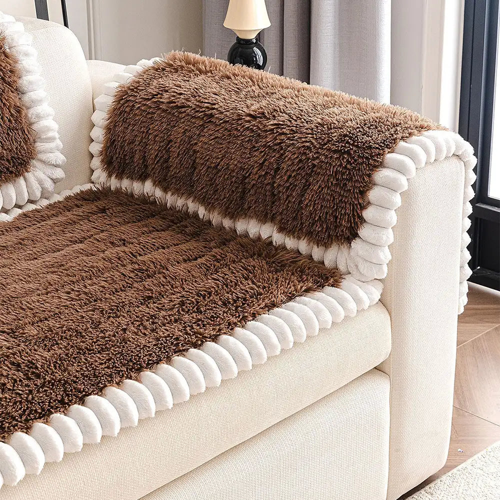 A full view of a living room showcasing a non-slip fluffy plush couch cover on a sectional sofa.