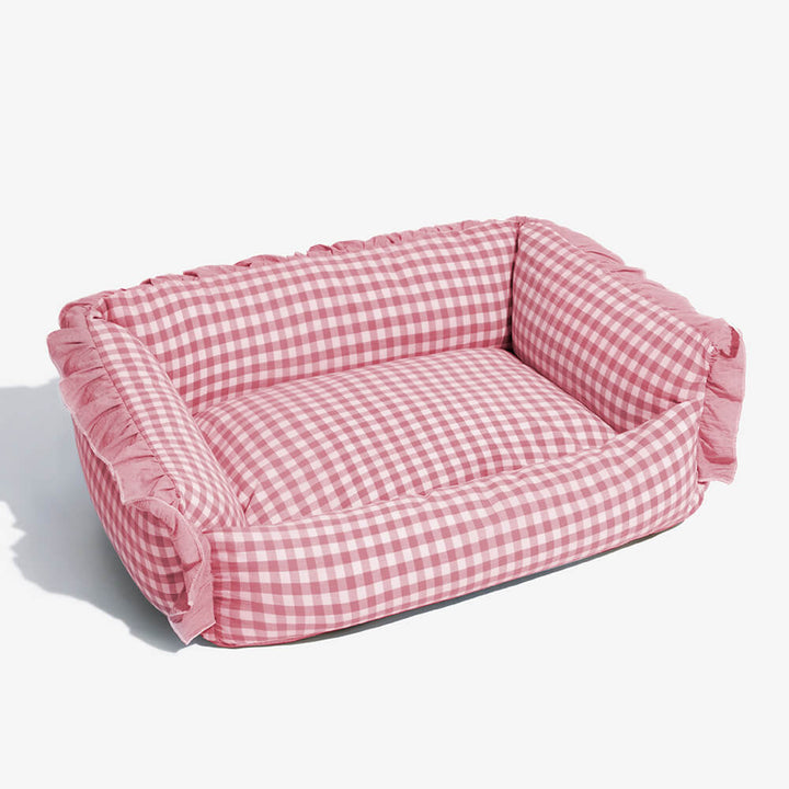 Plaid pet bed with ruffle trim, a luxurious and cozy accessory for any home