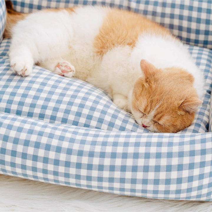 Soft pet bed, featuring a classic plaid print and charming ruffle accents