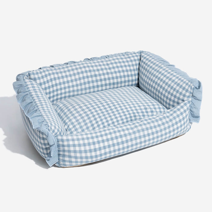Durable pet bed with a washable plaid cover and elegant ruffled edges for pets