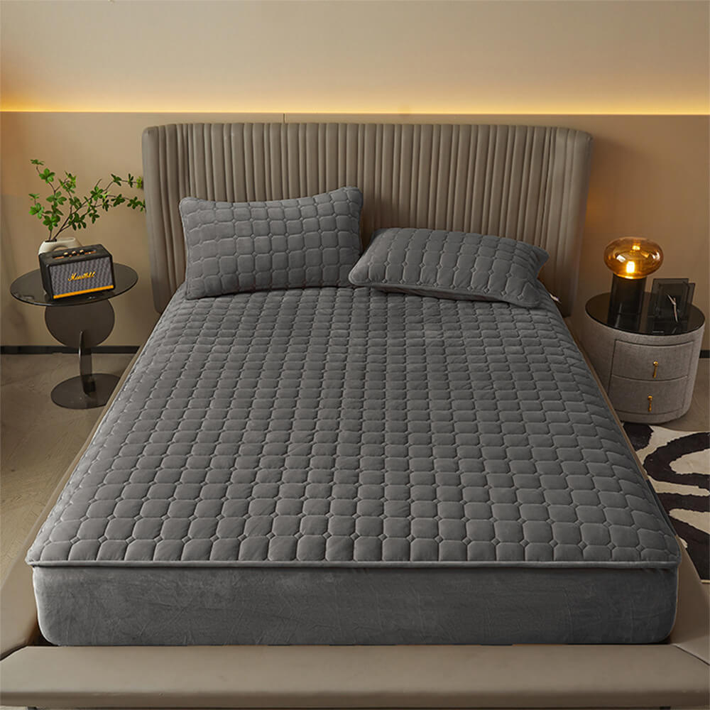 Luxurious plush velvet fitted sheet, dark gray, with matching pillowcases, enhancing cozy bedroom decor.