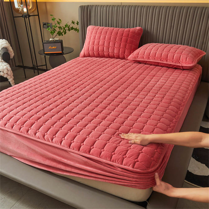 Soft, breathable velvet fitted sheet in a warm beige color, shown on a bed with two pillowcases.