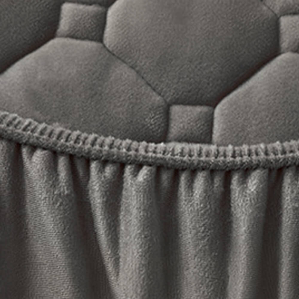 Close-up of a burgundy plush velvet fitted sheet texture, highlighting its warmth and luxurious feel.