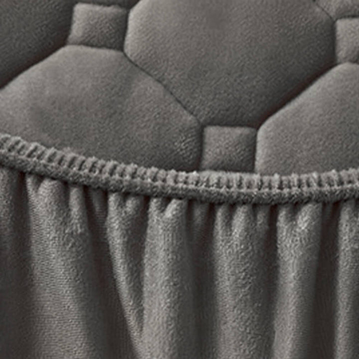 Close-up of a burgundy plush velvet fitted sheet texture, highlighting its warmth and luxurious feel.