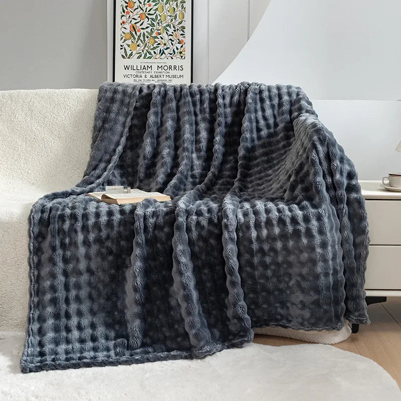 Soft, folded fleece blanket showcasing its plush texture & luxurious feel, perfect for a cozy home.