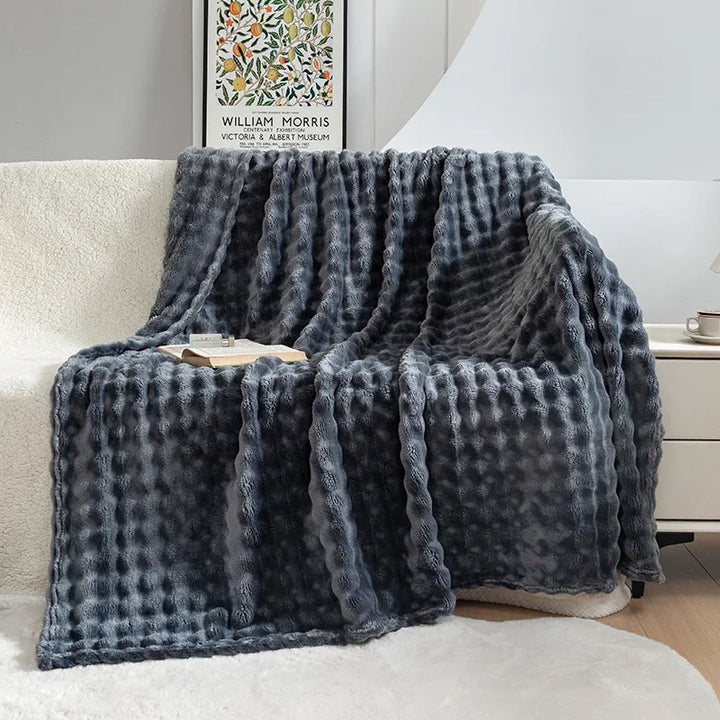 Soft, folded fleece blanket showcasing its plush texture & luxurious feel, perfect for a cozy home.