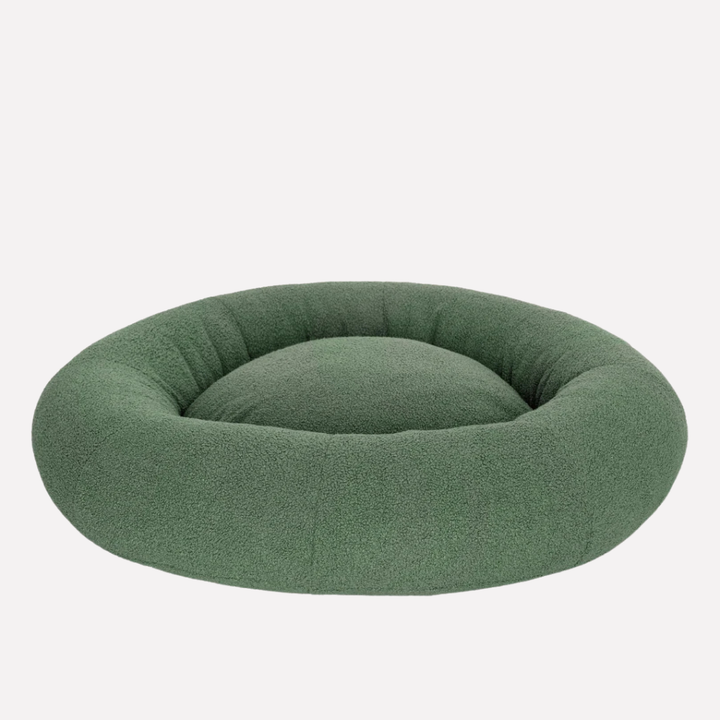 Cream boucle fabric pet resting spot. Neutral, washable dog and cat bed, a luxury animal accessory.