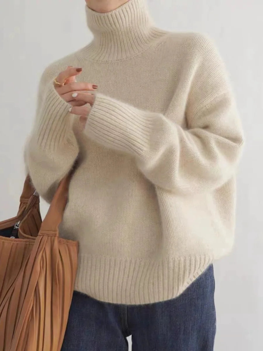 Luxurious warm women's turtleneck sweater in a relaxed fit. Perfect for cozy fall and winter comfort.