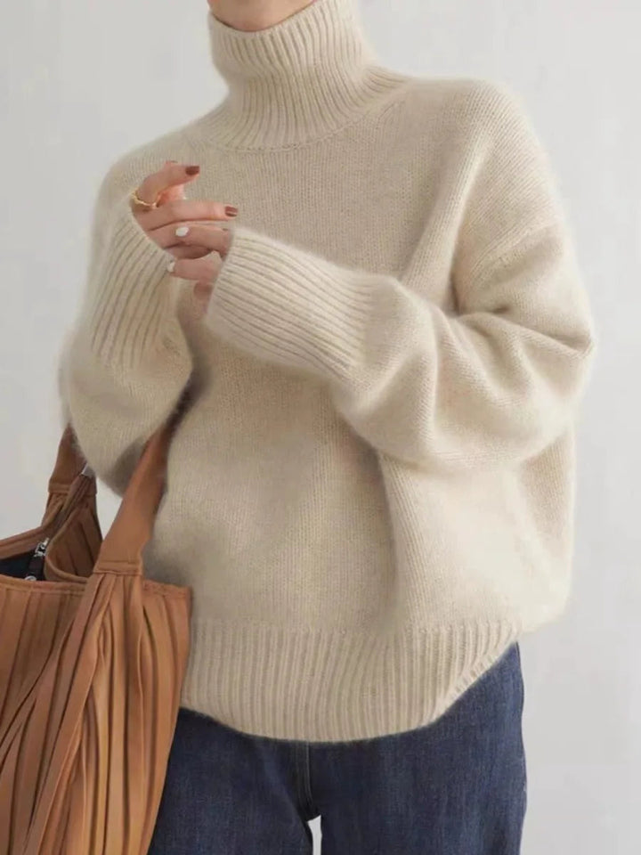 Luxurious warm women's turtleneck sweater in a relaxed fit. Perfect for cozy fall and winter comfort.