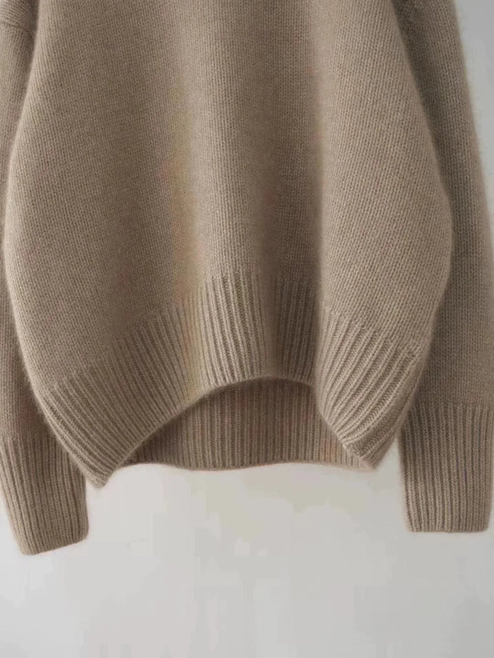 Relaxed fit women's luxurious turtleneck sweater. Soft fabric provides cozy warmth and elegance.