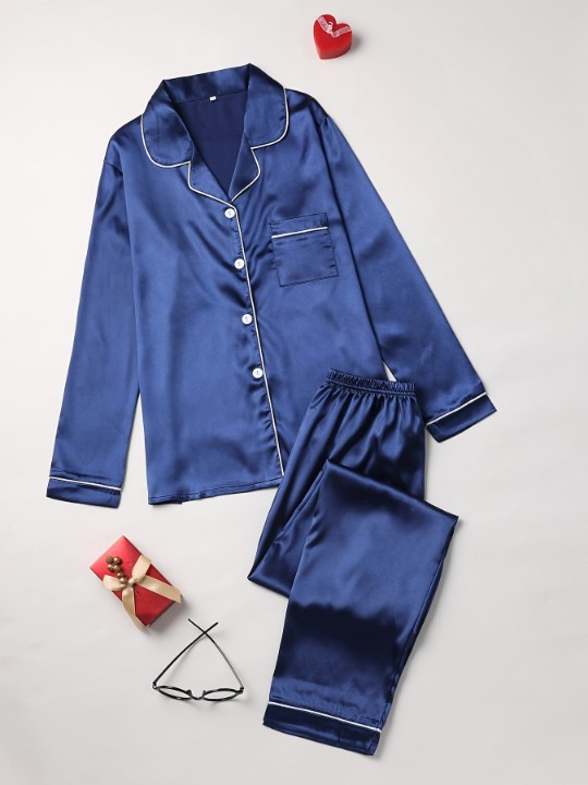 Close-up of smooth, glossy silk fabric on a luxurious women's pajama top, highlighting comfort & quality.