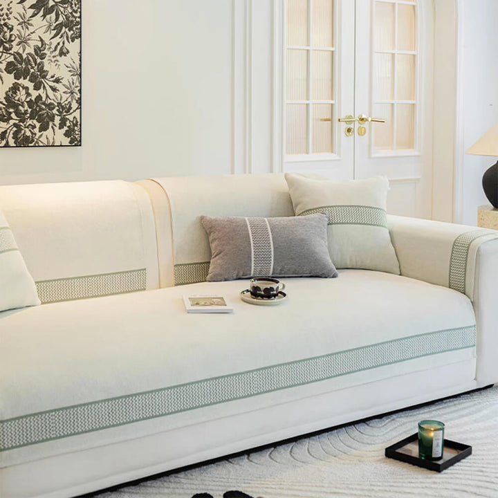 Corner of a sectional sofa draped with a non-slip, scratch-resistant chenille jacquard cover.