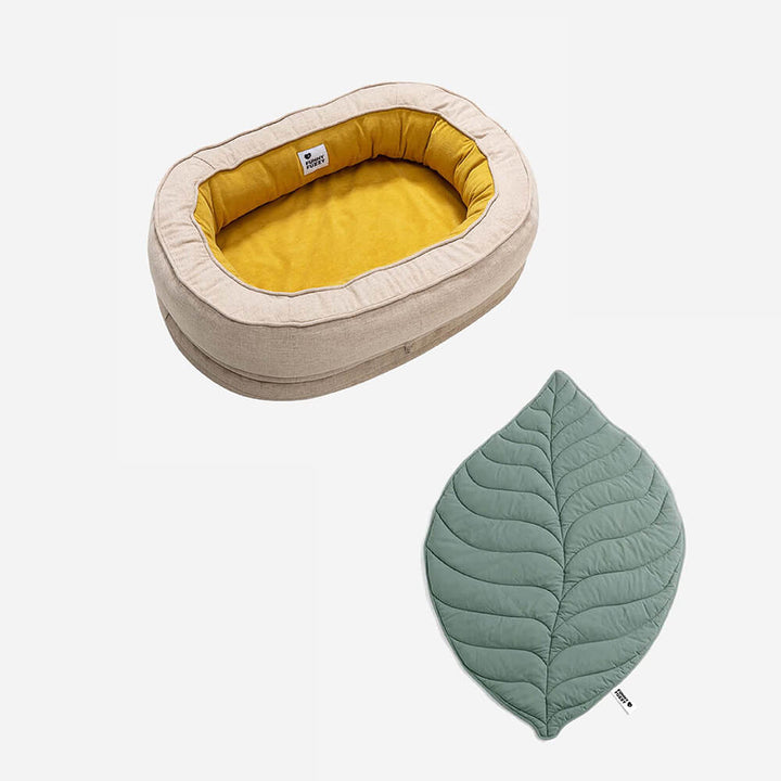 Cozy pet bed with an artistic leaf patterned blanket.