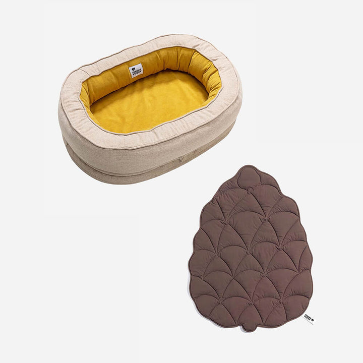 Donut dog bed with matching leaf blanket, ultimate relaxation.