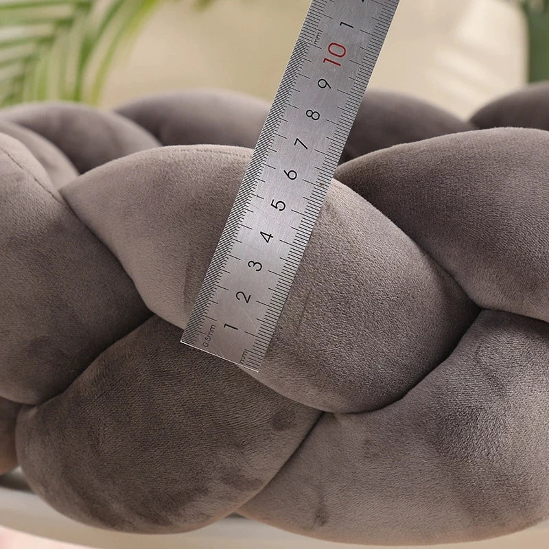 Overhead view of a round, fluffy washable dog bed in light gray, designed for pet calming.