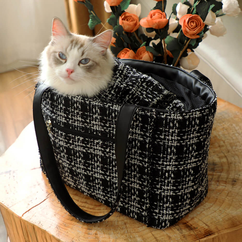 Luxury pet carrier featuring a distinctive tweed checkered fabric, a must-have pet accessory.