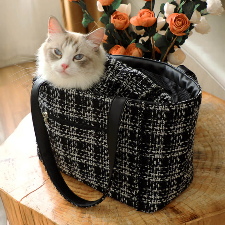 Luxury pet carrier featuring a distinctive tweed checkered fabric, a must-have pet accessory.
