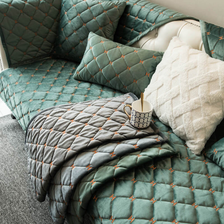 Textured shot of a non-slip quilted velvet couch cover, emphasizing its soft feel and durable design.