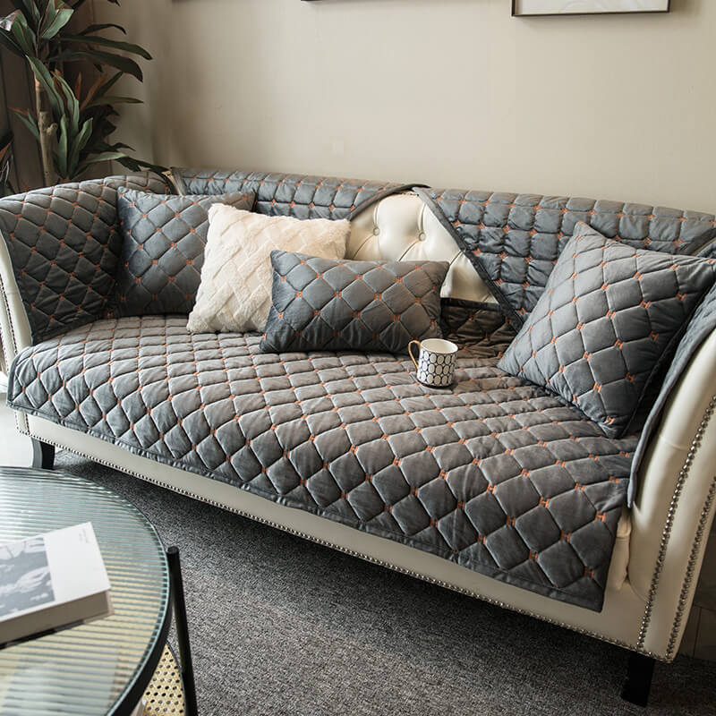 Full shot of a vibrant velvet quilted sofa cover, showcasing its non-slip features & luxury home decor.