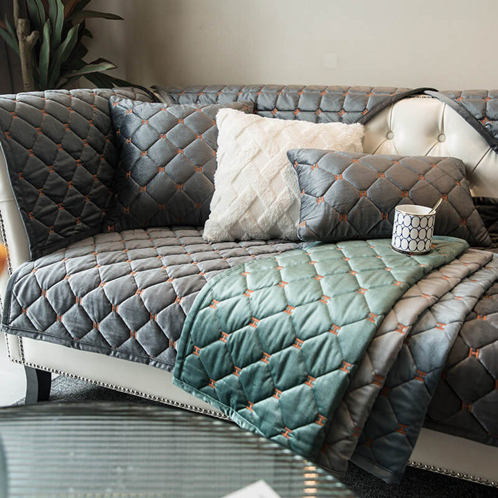 Plush velvet couch cover with quilted texture, offering superior furniture protection & a non-slip fit.