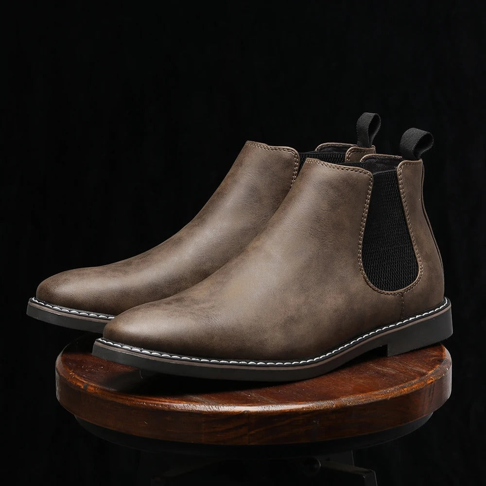 Modern men's grey slip-on Chelsea boots, blending comfort with contemporary men's fashion style.