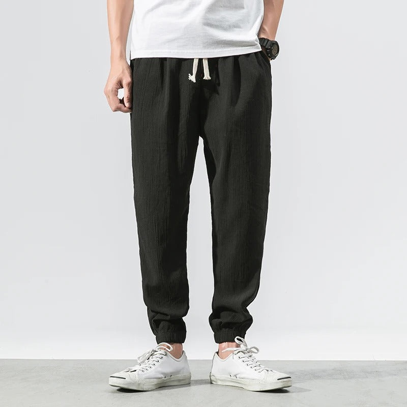 Model wears unisex ultra-lightweight comfort joggers, showcasing relaxed fit perfect for activewear & loungewear.