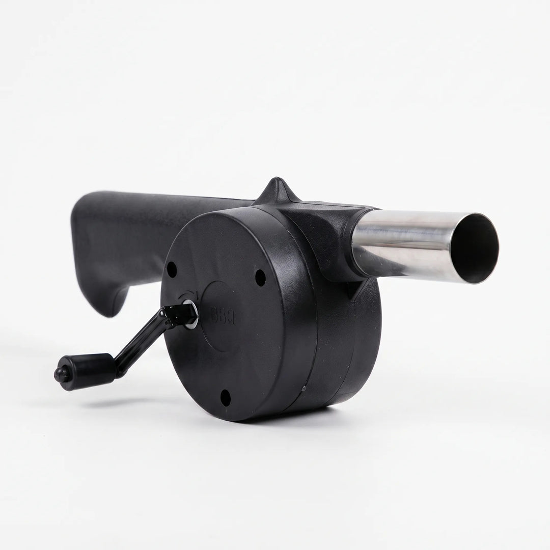 Efficient manual charcoal starter fan with hand crank, essential BBQ tool for quick fire ignition outdoors.