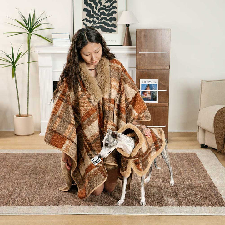 Matching red and black plaid poncho set for owner and dog, cozy polar fleece outerwear for winter.