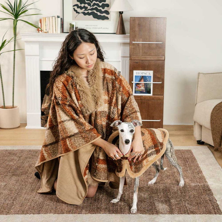 Red plaid dog poncho styled with other winter accessories, cozy and fashionable pet clothing.