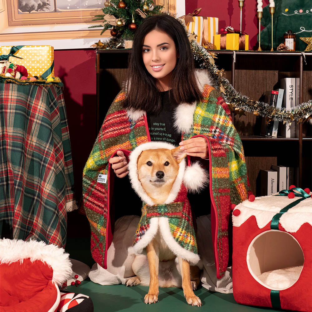 Matching plaid ponchos for a pet and its owner, highlighting the quality polar fleece material.